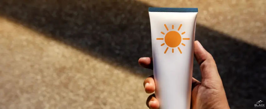 BML-Person Holding Sunscreen Bottle