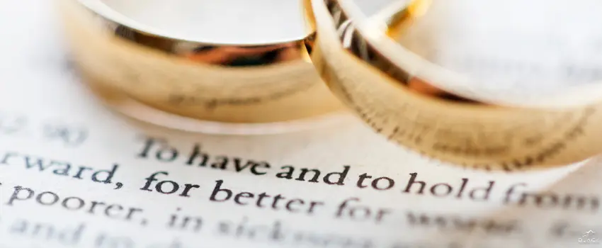 BML-Two gold wedding rings on top of a bible