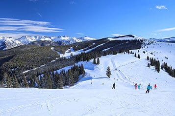 People were skiing down the mountains of Vail Ski Resort in Colorado on a cold winter day.