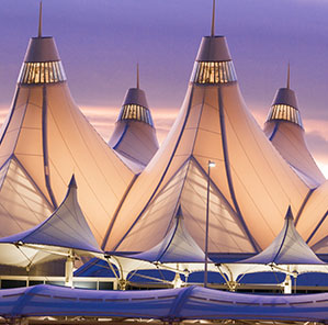 Glowing tents of Denver International Airport at sunrise.